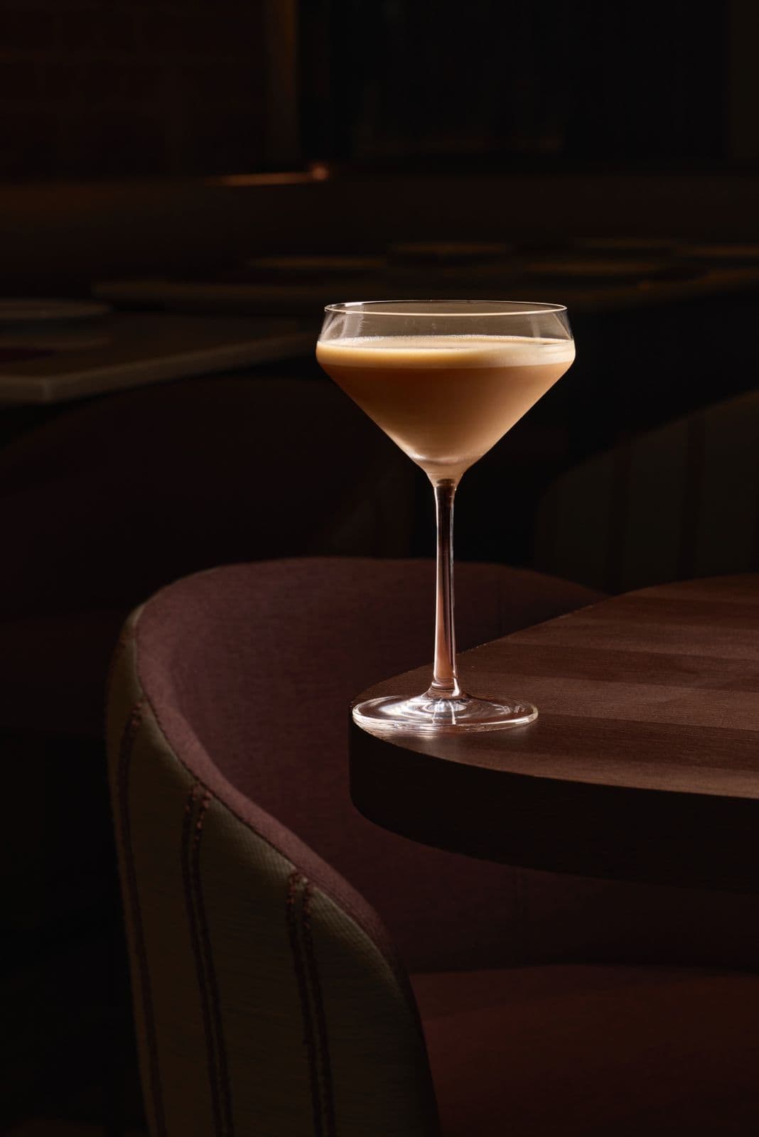 Espresso martini by a wooden table in the dining room