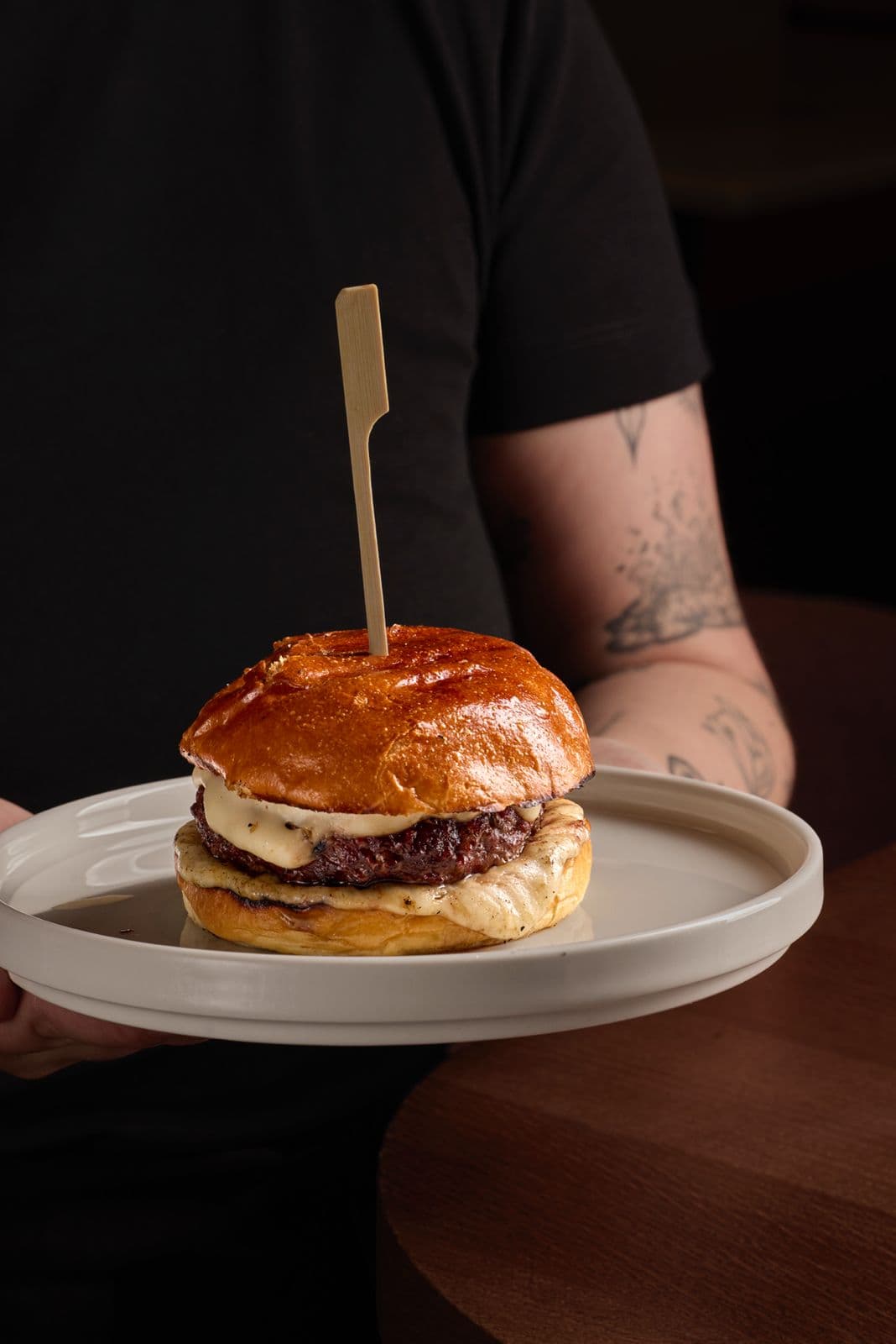 5 Gallos Burger with cheese sauce on a brioche bun
